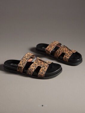Bibi Lou cutout slide sandals. Anthropologie. Color: Leopard Suede print